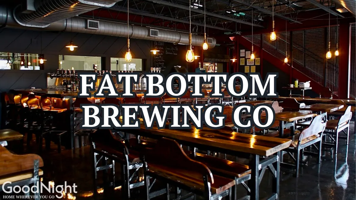 An inviting interior of a craft beer venue with long wooden communal tables, warm industrial lighting, and a visible bar area. People gather to taste unique brews and socialize, capturing a sense of community and relaxed enjoyment.