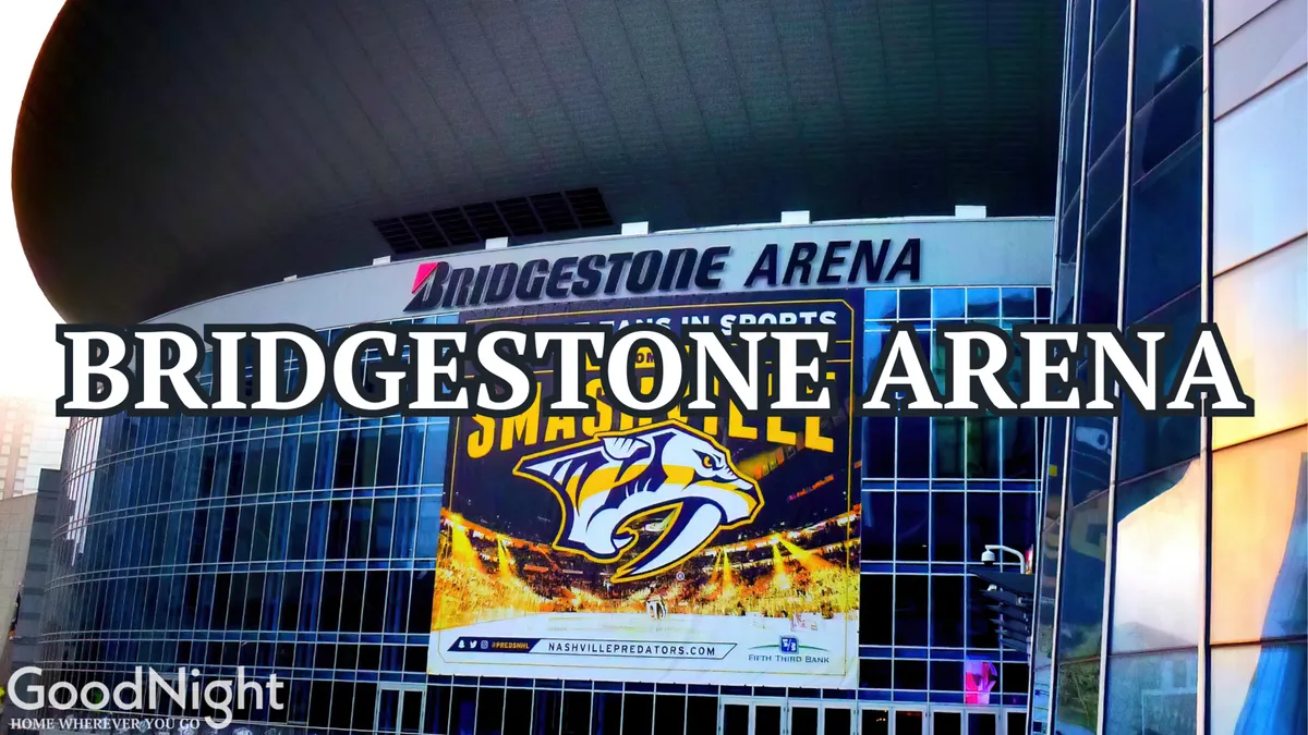 This exterior shot of Bridgestone Arena features bold signage and a prominent Nashville Predators banner on the reflective glass facade, capturing the excitement of one of Nashville’s most iconic music and sports venues.